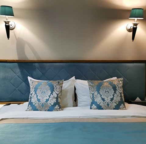 Кровать в гостинице Xander Hotel