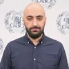 Старший преподаватель кафедры экономической теории РЭУ им. Г. В. Плеханова.  Ходжа Кава