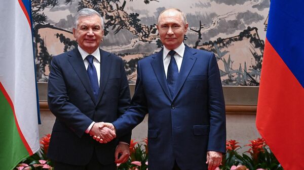 Президент РФ Владимир Путин и президент Узбекистана Шавкат Мирзиёев во время встречи в Пекине