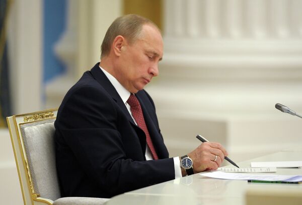 Владимир Путин подписывает документ