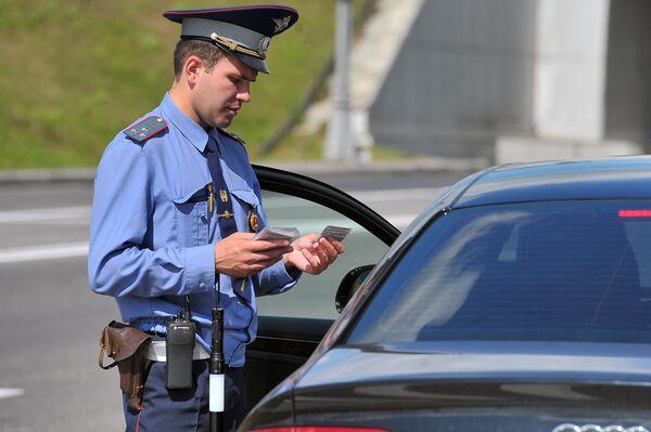Сотрудник ГИБДД проверяет документы у водителя на посту ДПС на 78-м километре МКАД