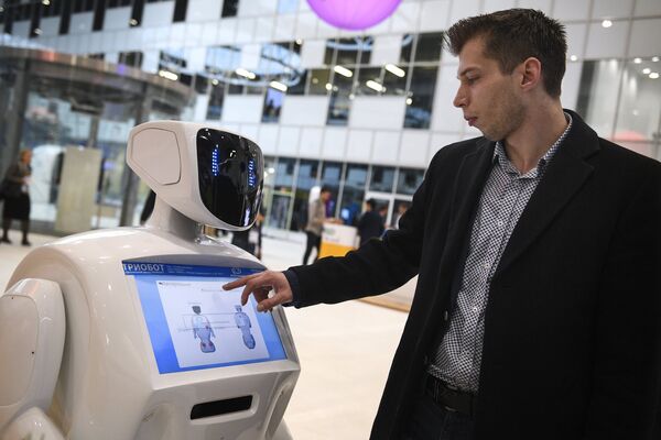 Посетитель у информационного робота Promobot на форуме Открытые инновации - 2016