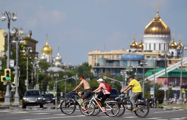 Люди катаются на велосипедах возле Фрунзенской набережной в Москве